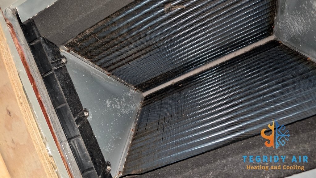 Evaporator coil inspection showing buildup on indoor AC coil Kenner Louisiana